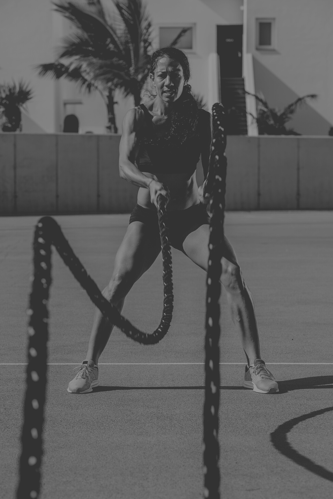 Woman training with cross fit rope