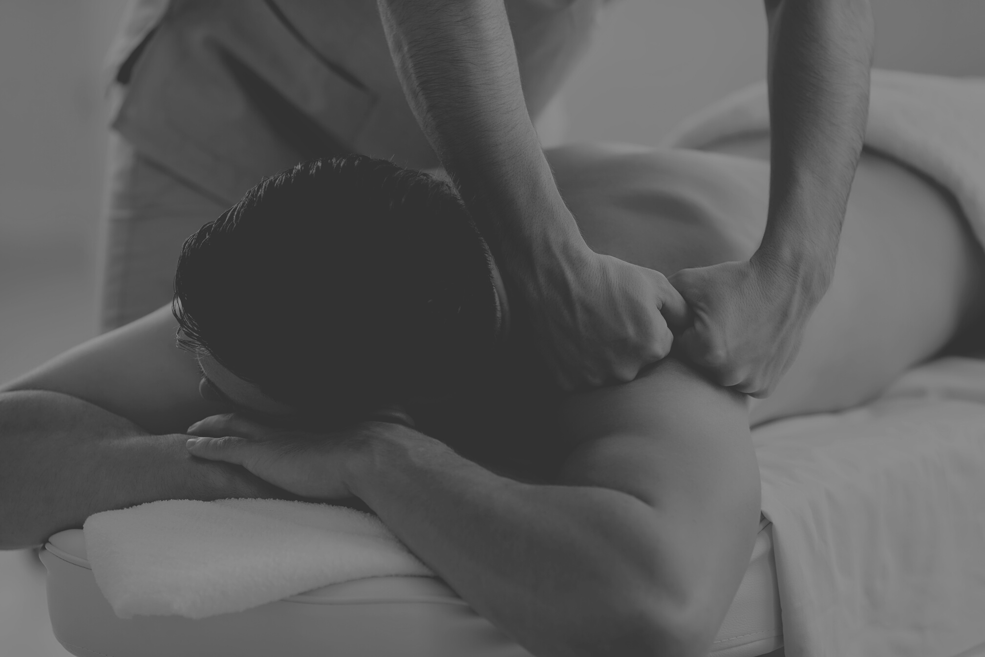 Young Man Getting Professional Remedial Body Massage in Massage Room or Health Center